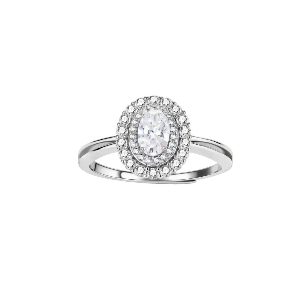 Sterling silver ring with oval moissanite center stone surrounded by double halo of sparkling stones on neutral background.