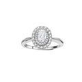 Sterling silver ring with oval moissanite center stone surrounded by double halo of sparkling stones on neutral background.