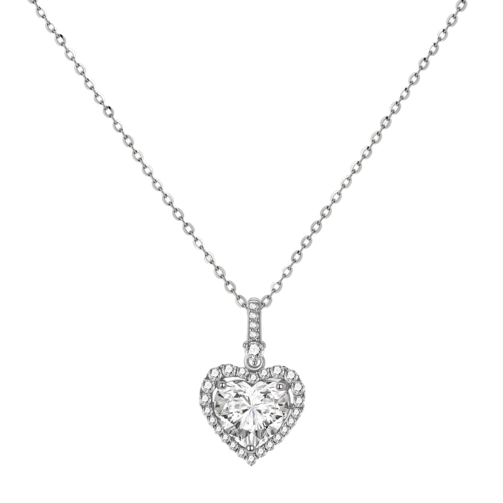 Complete jewelry set with heart-shaped sterling silver pieces featuring brilliant moissanite stones on white background.