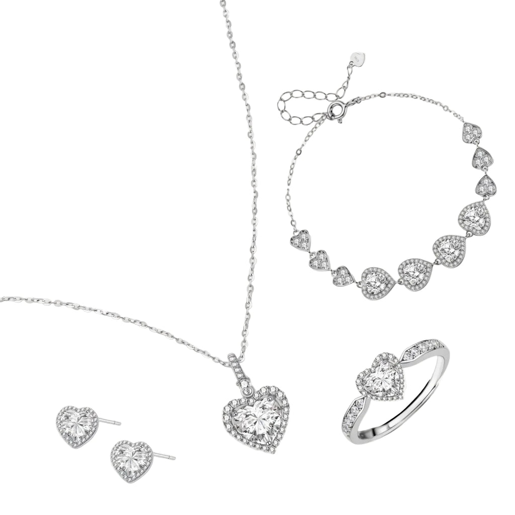 Complete jewelry set with heart-shaped sterling silver pieces featuring brilliant moissanite stones on white background.