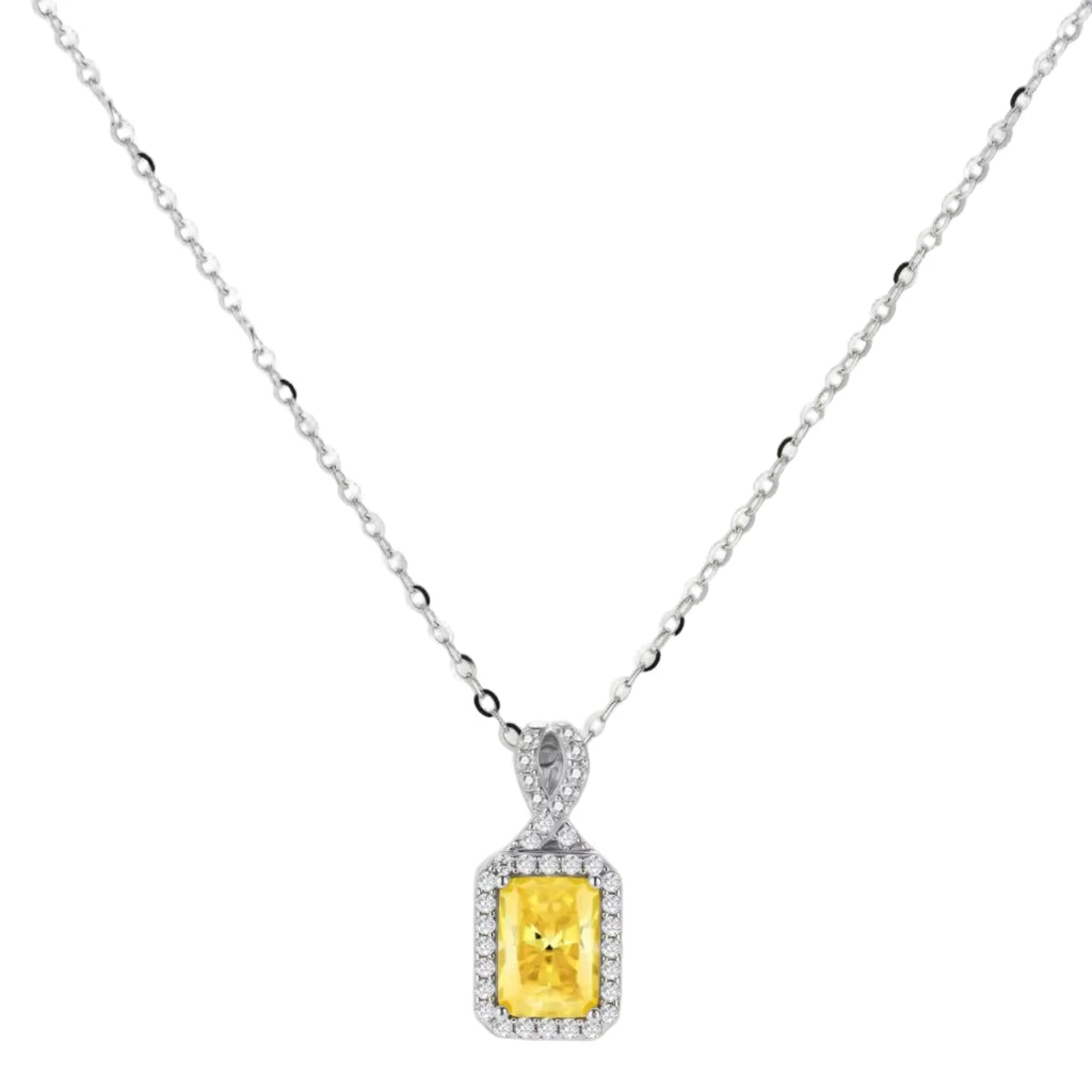 Yellow moissanite jewelry set with emerald-cut stones in sterling silver halo settings on white background.