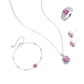 Sterling silver jewelry set featuring pink moissanite stones in halo settings on white background.