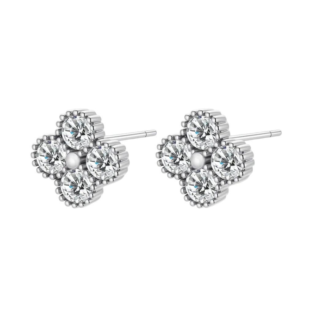 Dainty sterling silver quatrefoil stud earrings with four brilliant moissanite stones and center accent on white background.
