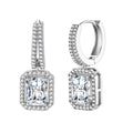Sterling silver huggie hoops with emerald-cut moissanite drops featuring pavé-set crystals on white background.
