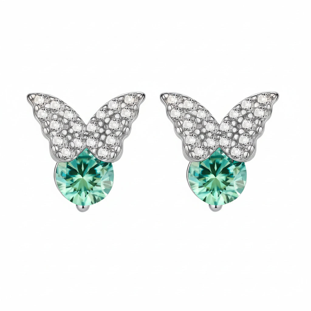 Sterling silver butterfly stud earrings with crystal wings and mint green center stones on cream background.