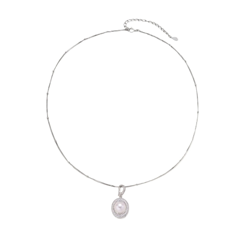 Oval sterling silver pendant with crystal halo surrounding a white freshwater pearl on delicate chain