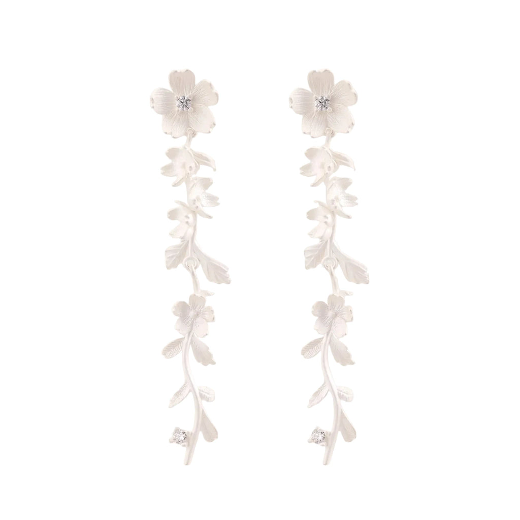 Long sterling silver drop earrings with delicate floral vine design and crystal accents on white background