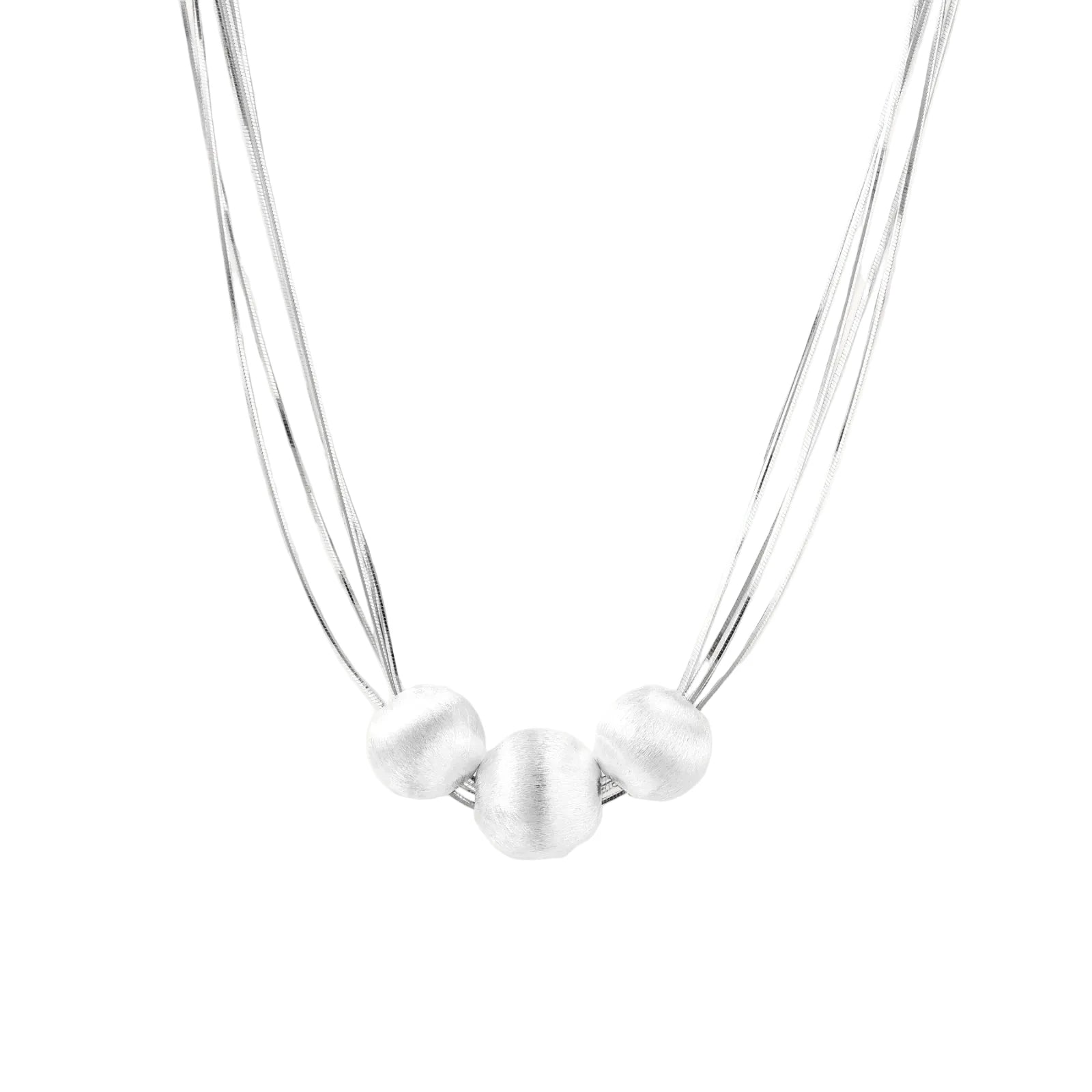 Sterling silver multi-strand necklace with three brushed round beads on cream background