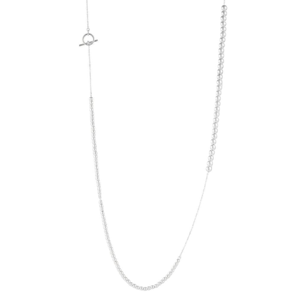 Long sterling silver beaded necklace with graduated sphere design, toggle clasp, and delicate chain extension on white background