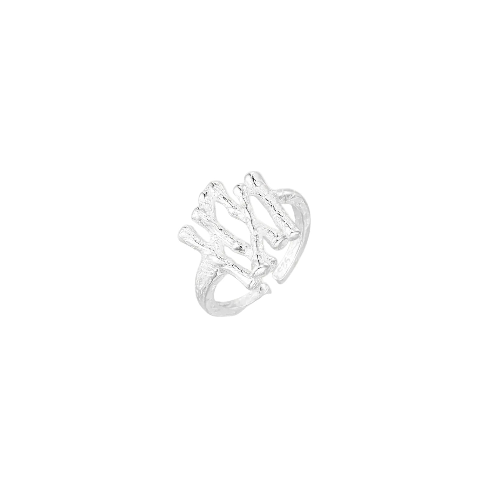 Sculptural sterling silver ring with organic branch design and textured surfaces on cream background