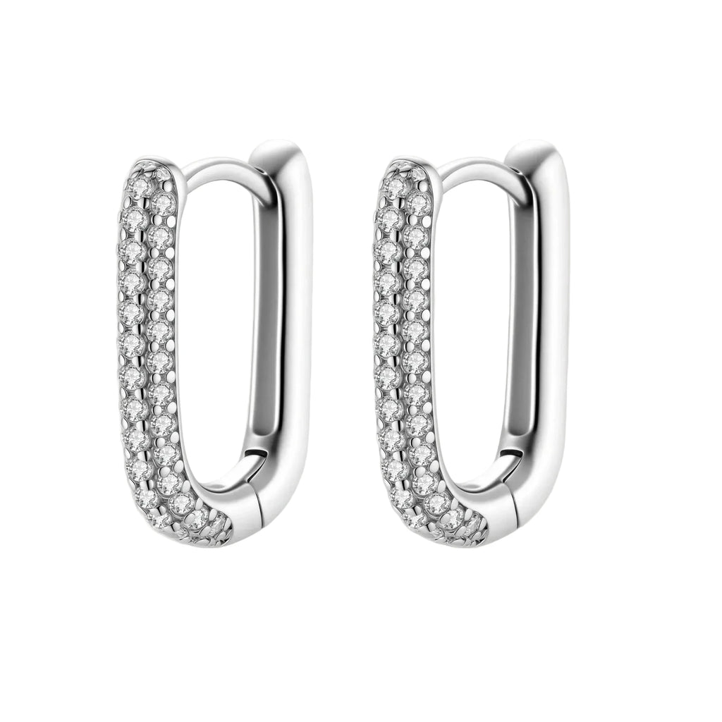 Close-up of platinum-plated sterling silver huggie hoops with pavé crystal setting on white background.
