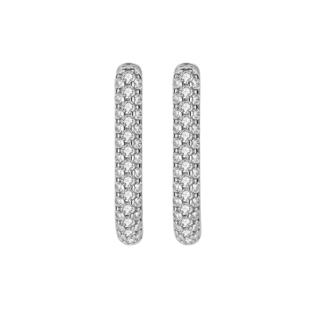 Close-up of platinum-plated sterling silver huggie hoops with pavé crystal setting on white background.